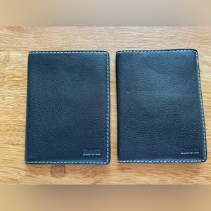 Roots black leather passport wallets.